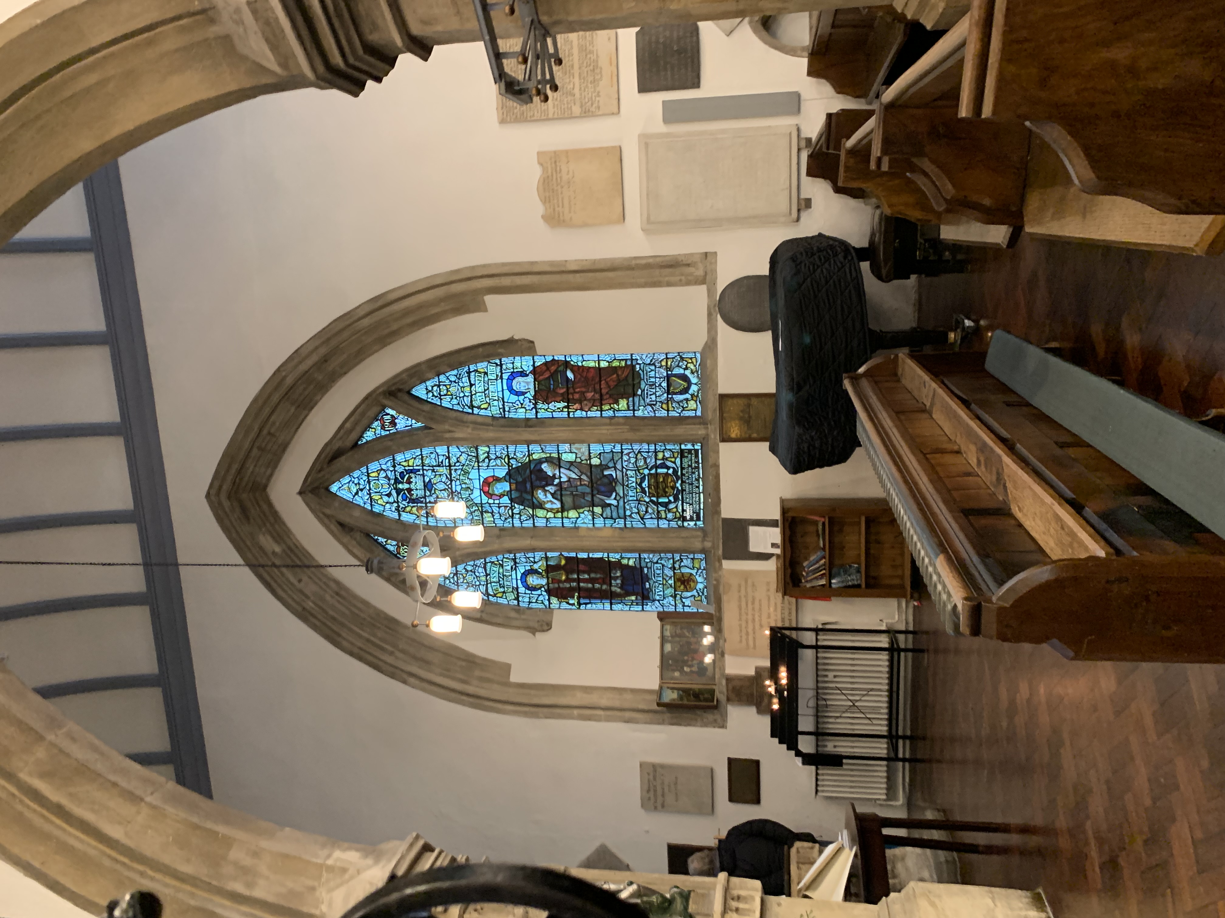 Side view of stained glass (and pews) inside St. Michael at the North Gate.